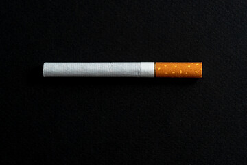 One cigarette evenly spaced on a black background.