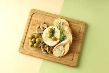 Concept of tasty food with grilled camembert on two tone background