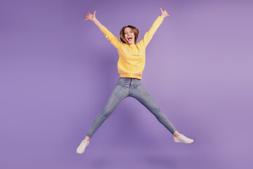 Portrait of charming active energetic funny lady jump have fun on violet background