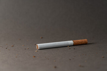 One cigarette on a gray background for a copy space.