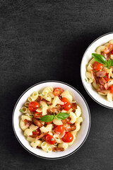 Pasta with bacon, tomato, parmesan cheese and basil leaves
