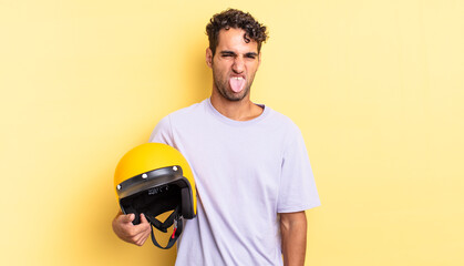 hispanic handsome man feeling disgusted and irritated and tongue out. motorbike helmet concept
