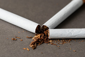 Three cigarettes with connected edges. on a gray