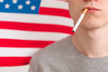 Cigarette and a man's face on the background of the usa