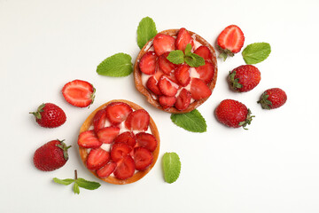 Delicious strawberry tarts on white background, top view