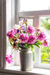 Fototapeta na wymiar Old window and a bouquet of pink peonies