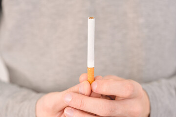 A man offers to smoke a cigarette. One cigarette is pulled
