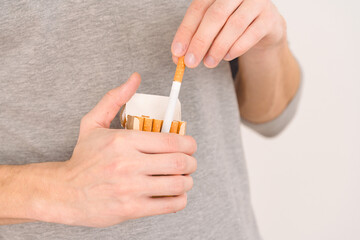 A man's hand will give one cigarette from a pack
