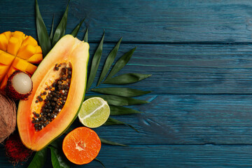 Fresh ripe exotic fruits on wooden background