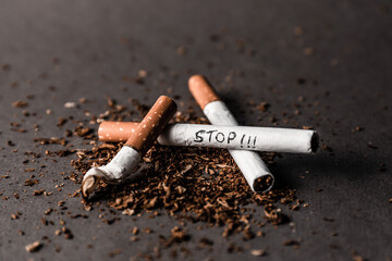 Stop cigarette with tobacco scattered around. Concept