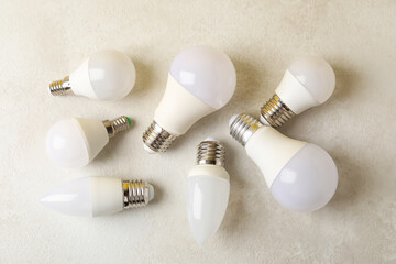 Energy saving bulbs on white textured background