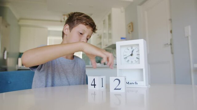 Boy flips Handmade wood cubes with date day 8 marh holiday, International Women's Day.