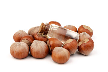 Hazelnut oil in glass bottle isolated on white background. Hazelnut background, healty food