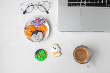 Halloween Cookies,  hot coffee and computer laptop on white background. Happy Halloween, online shopping, Hello October, fall autumn, Festive, party and holiday concept