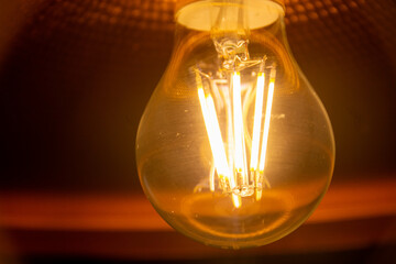 Vintage hanging light bulb on a dark background. Loft style.