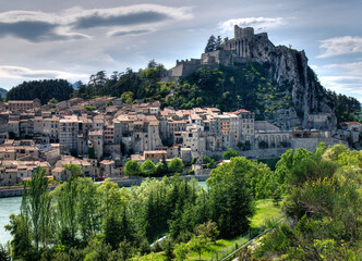 Fototapeta premium View To The Fortress Of Sisteron High Above The Old Town At The River Durance In France On A Beautiful Spring Day With A Clear Blue Sky France On A Beautiful Summer Day With A Few Clouds In The Sky