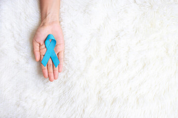 November Prostate Cancer Awareness month, Man holding light Blue Ribbon for supporting people...