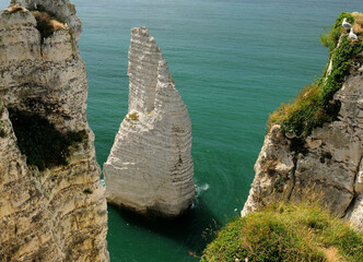 Naklejka premium Sea Stack In The Green Shimmering Sea At The Steep Chalk Cliff Coast Of Etretat Normandy France On A Beautiful Summer Day
