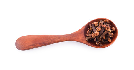 Clove in a spoon isolated on a white background.