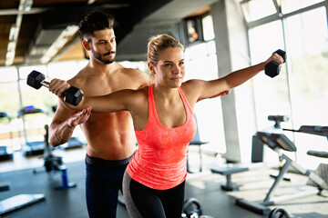 Personal trainer assisting woman to lose weight. Sport exercise people healthy lifestyle concept