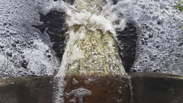 Waste water with abundance of phosphorus - full of organic substances and detergents flows down pipe and forms plentiful foam, biofouling and detergent eutrophication. Super slow motion 1000 fps.