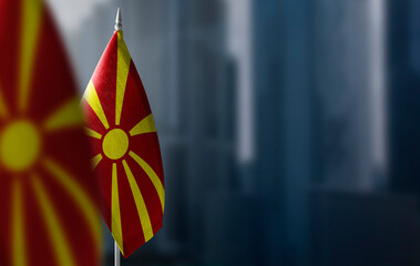 Small flags of Macedonia on a blurry background of the city