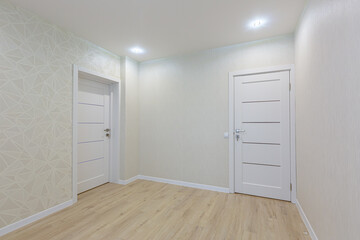 Interior photo of a room without furniture after renovation in light colors