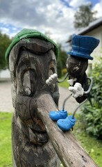 pinocchio wooden statue long nose cricket cloudy sky