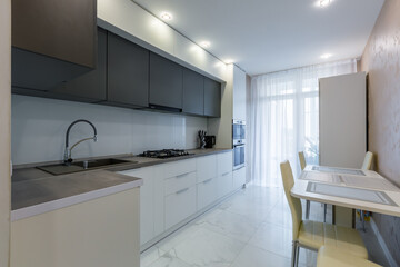 kitchen interior with gray inserts and dark elements in a modern style