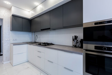 kitchen interior with gray inserts and dark elements in a modern style