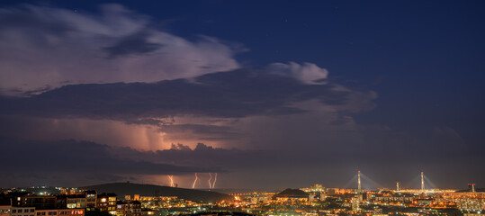 Obraz na płótnie Canvas Lightning storm at night over city.