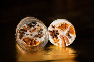 Soy Candles poured into recycled bottles and jars. Many soy wax candles together on store or workshop background. . Ecological and vegan business.