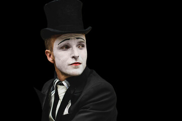 portrait of elegant expressive male mime artist posing on black background. Close-up portrait of a male mime artist. Halloween costume.