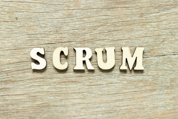 Alphabet letter in word scrum on wood background