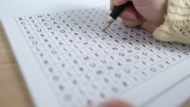 female hand close-up draws lines on paper, spell out and spell word in a square, concept of brain development in old age, therapeutic health support, preventive fight against senile dementia