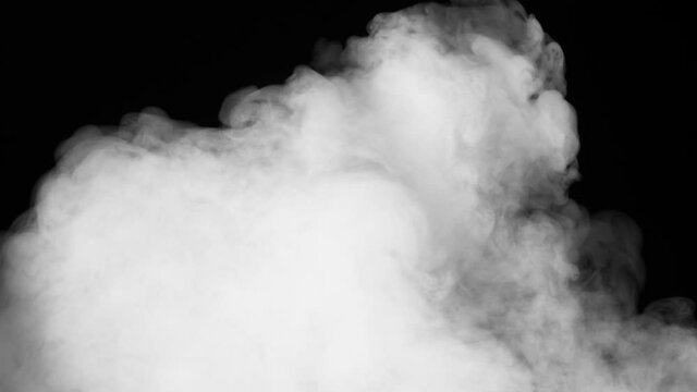 White Smoke Covers a Black Screen. A jet of white smoke creates an elegant transition between frames with the blending mode "Stencil Luma" and other methods