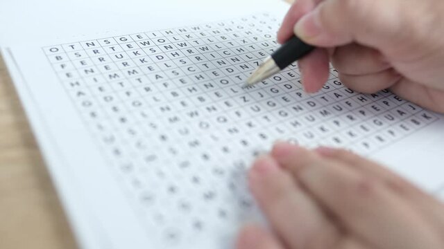 female hand close-up draws lines on paper, spell out and spell word in a square, concept of brain development in old age, therapeutic health support, preventive fight against senile dementia