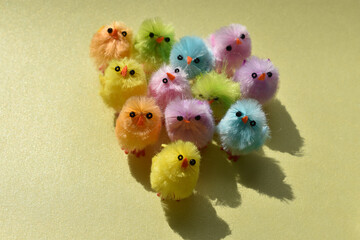 Cute fluffy Easter chicks multi coloured in a group on pastel colour background