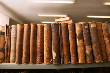 Collection of old books on shelf in library