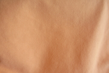 Light orange simple cotton jersey fabric from above
