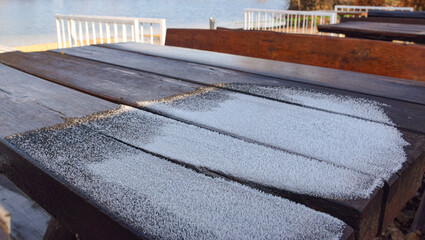 Hoarfrost on the table by the lake.