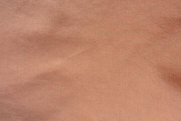 Texture of apricot colored simple cotton jersey fabric