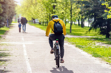 Fototapeta na wymiar Cyclist ride on the bike path in the city Park 
