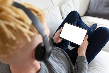 Albino african american man in the living room using tablet with copy space