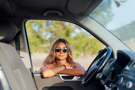 Woman with sunglasses leaning on van window