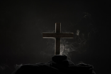 The smoke from the burning of the cross on a black and dark background