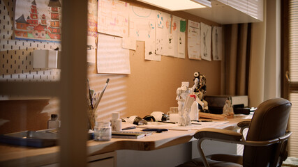 Empty room with boy's workplace. Desk with paintbrushes and robot model