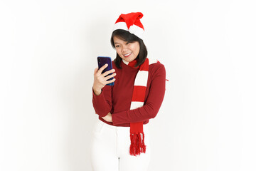 Holding and using smartphone of Beautiful Asian Woman Wearing Red Turtleneck and Santa Hat  Isolated On White Background