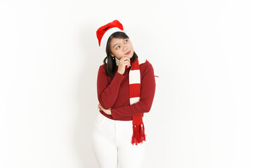 Obraz premium Thinking Gesture of Beautiful Asian Woman Wearing Red Turtleneck and Santa Hat Isolated On White Background
