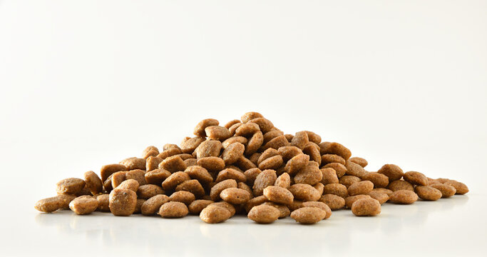 Pile of dry food kibbles for pets on white front